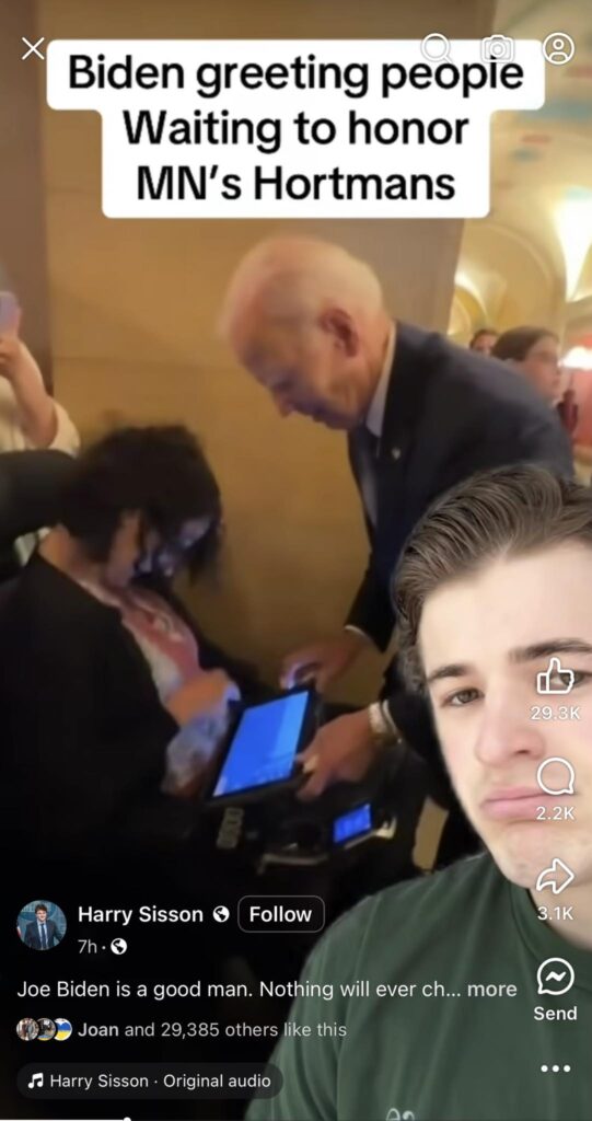 A still image from a social media video. President Joe Biden is shown bending down to greet a young woman in a wheelchair inside the Minnesota Capitol building. Text overlayed on the image states “Biden greeting people waiting to honor MN’s Hortmans.” You can see comments and lots of social media engagement at the bottom; the post was liked by almost 30,000 people.